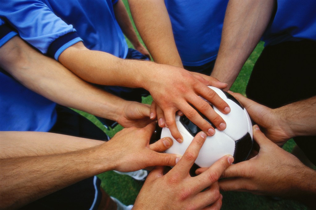 Multiple Players Holding Soccer Ball