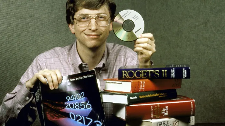 young bill gates behind a pile of books